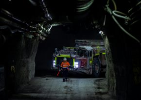 Miner and a truck in underground mine. Source: Photo by Munkh-Erdene Eenee on Unsplash.